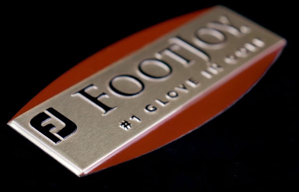 multi-level embossed aluminum badge increases value for the brand